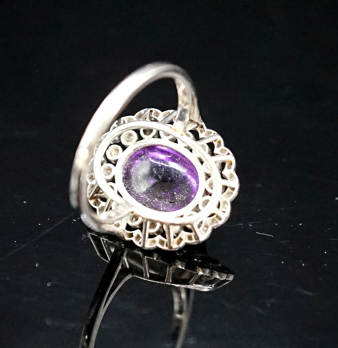 A 1920's white metal, cabochon amethyst and rose cut diamond ring, size M, gross weight 5.9 grams.
